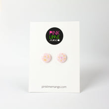 Load image into Gallery viewer, handcrafted bubble-gum pink resin statement studs. They contain the most amazing aurora glitter flakes. Colour changing iridescent pieces which shine when they catch the light. The earrings posts are made of sterling silver. Earrings shown on a Pink Lime Mango backing card
