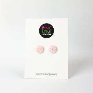 handcrafted bubble-gum pink resin statement studs. They contain the most amazing aurora glitter flakes. Colour changing iridescent pieces which shine when they catch the light. The earrings posts are made of sterling silver. Earrings shown on a Pink Lime Mango backing card