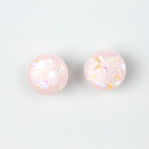 handcrafted bubble-gum pink resin statement studs. They contain the most amazing aurora glitter flakes. Colour changing iridescent pieces which shine when they catch the light. The earrings posts are made of sterling silver.