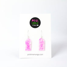 Load image into Gallery viewer, Delicate arches of clear resin with bursts of pale pink and tiny shimmery flower sequins. The unique V shaped earring hooks are made of sterling silver. On a Pink Lime Mango backing card.
