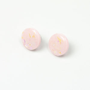 handcrafted bubble-gum pink resin statement studs. They contain the most amazing aurora glitter flakes. Colour changing iridescent pieces which shine when they catch the light. The earrings posts are made of sterling silver.