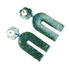 Load image into Gallery viewer, Earring backs. Handcrafted resin arch earrings that are jam packed with sparkly teal blue, green and gold glitter! These beauties have flower stud tops and look fabulous on!
