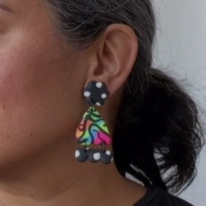 A video still of Vicky from Pink Lime Mango modelling handcrafted Super Neon Sisters earrings for size reference. Bright, bold and colourful earrings made in Bristol UK